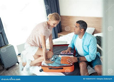 Husband And Wife Trying To Make Their Travelling Case Smaller Stock Image Image Of Fitting