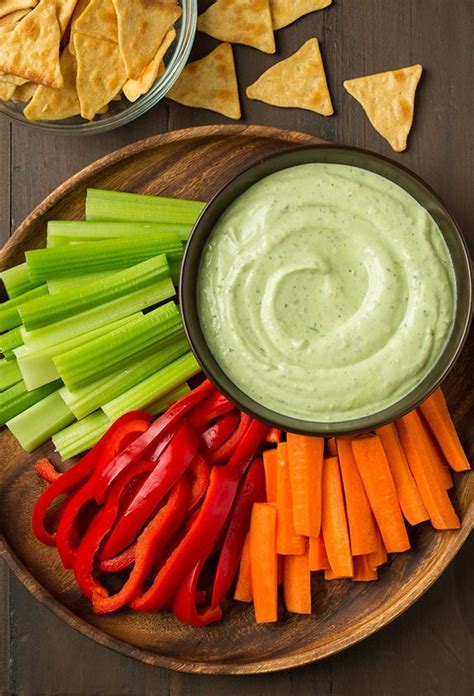 A Plate With Carrots Celery And Red Peppers Next To Ranch Dip