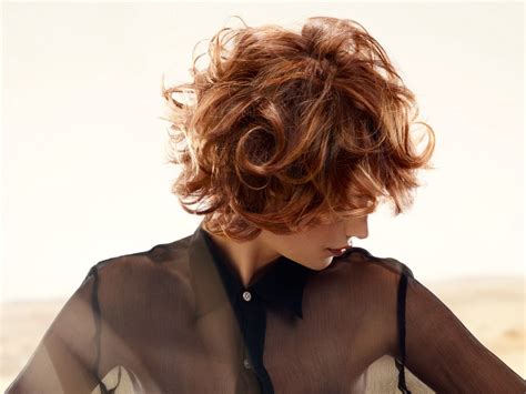 The shape of those big waves is very appealing for women everywhere. Short hairstyle with large curls and highlights for visual ...