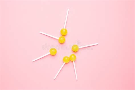 Sweet Yellow Candy Lolipop On Pastel Pink Background Minimalist