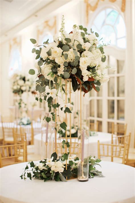 You're planning the party of a lifetime, and we are here to help you. tall lush wedding reception arrangement in all white ...