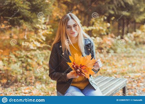 Cute Smiley Woman Holding Autumn Leaves In Fall Park Seasonal
