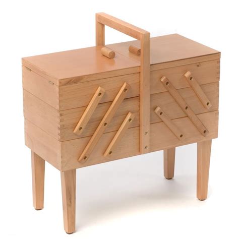 A Wooden Toy Chest With Handles And Drawers On It S Legs Against A