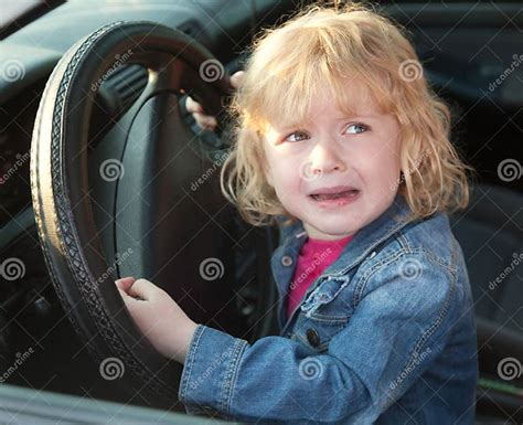 Upset Little Girl Crying In The Car In Soft Focus Stock Photo Image