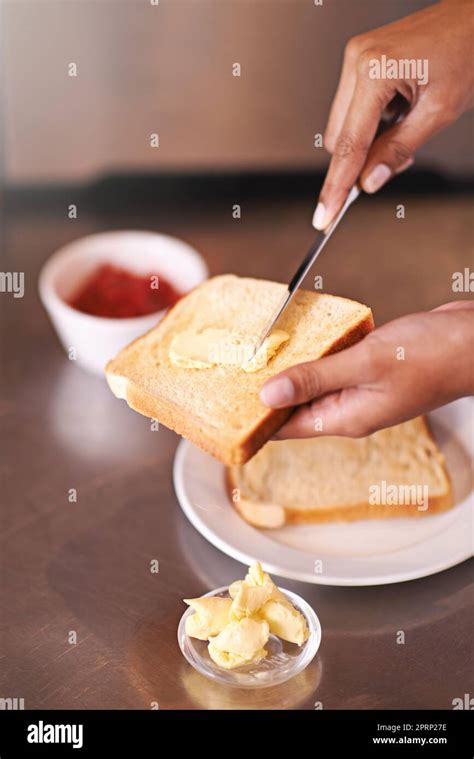 Spreading On Some Buttery Goodness A Woman Spreading Butter Onto Toast Stock Photo Alamy