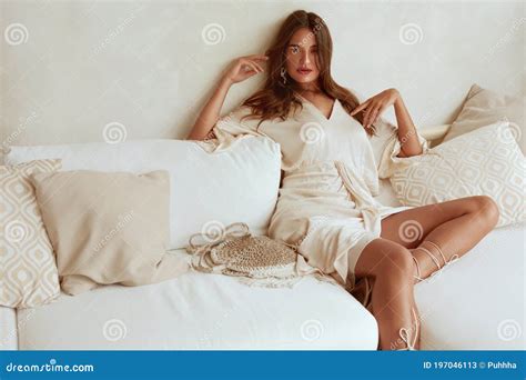 Beautiful Girl Sitting On Sofa Portrait Seductive Woman In Casual Outfit With Knitted Bag
