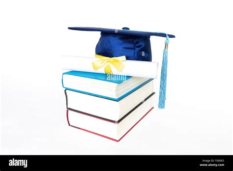 Blue Graduation Cap With Diploma On Top Of Books Isolated On White