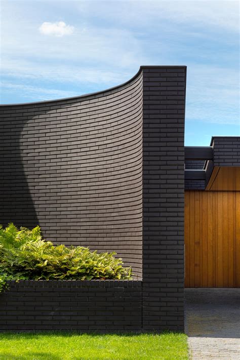 This Home Combines A Black Brick Exterior With Large Glass