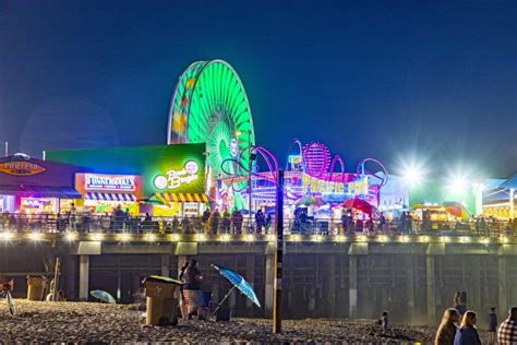 people enjoy the ocean park at santa monica pier by night editorial image image of monica