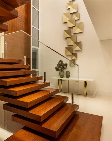 A Staircase With Wooden Steps And Glass Railing