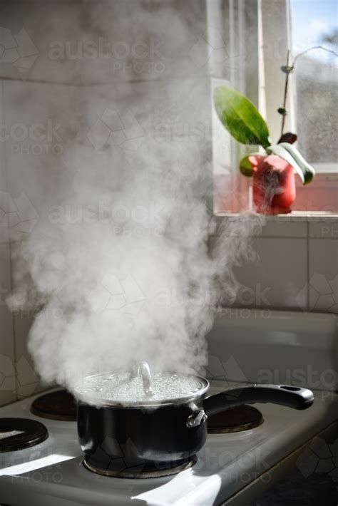 Image Of A Boiling Pot On A Stove Releases Lots Of Steam Into The