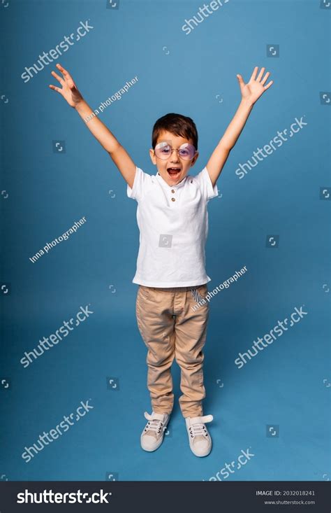 Happy Little Boy Triumphant Raised Hands Stock Photo 2032018241