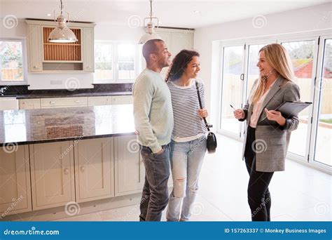 Buying A House Concept With Woman Hands Holding A Model House And Keys