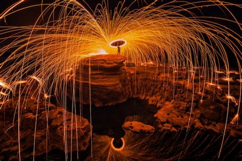 Premium Photo Burning Steel Wool On The Rock Near The River