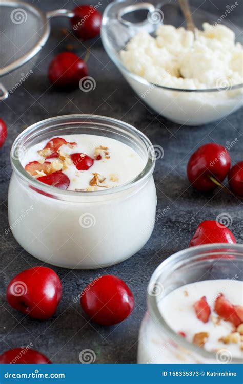 Fermented Yogurt Kefir In Small Bottles With Cherries And Walnuts Stock