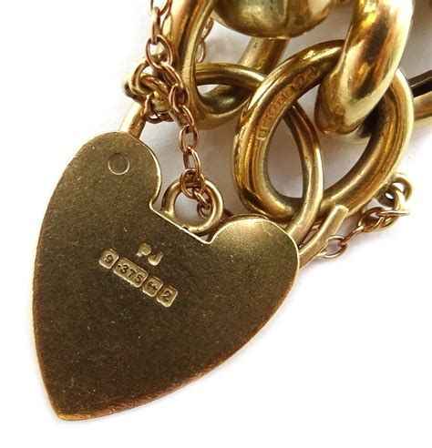 Heavy 9ct Gold Curb Heart Locket Bracelet With Sixteen 9ct Charms