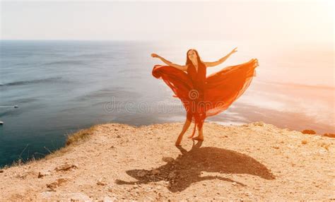 Woman In Red Dress On Sea Side View A Young Beautiful Sensual Woman In