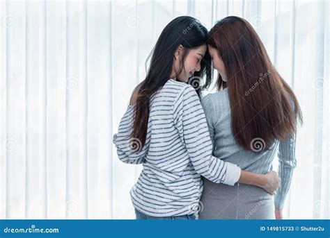 Two Asian Lesbian Women Looking Together In Bedroom Couple People And Beauty Concept Stock