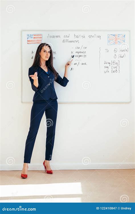 Female Teacher Giving A Lecture Showing Presentation On Whiteboard