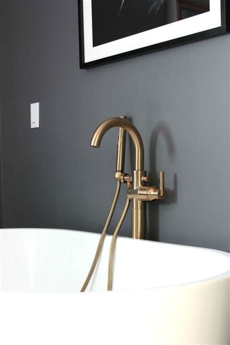 The steel and glass wall is by space exploration design. Delta Champagne Bronze Faucets and Fixtures in the Master Bathroom | Bronze bathroom fixtures ...