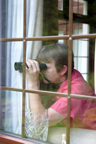 Nosey Neighbour At The Window With Binoculars Stock Photo Download