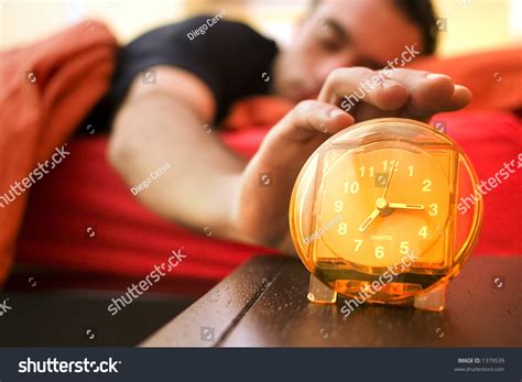 Man Waking Up And Snoozing The Alarm Stock Photo 1379539 Shutterstock