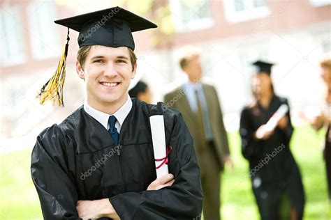 Graduation Student Standing With Diploma Stock Photo By ©sjlocke 24574561
