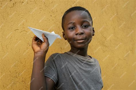 Free Photo Portrait Little African Boy Playing With Airplane