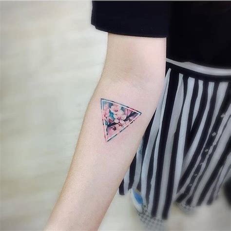 Triangle tattoo designs have become very popular and have been seen on celebrities like rita ora we love triangle tattoos and wanted to share some of our favorites. Cherry blossom triangle tattoo.