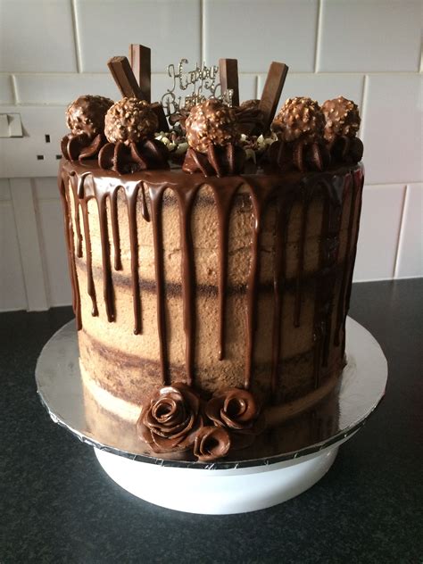 A Cake With Chocolate Icing And Decorations On Top