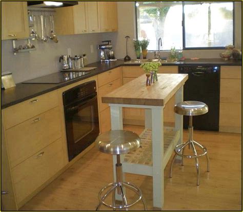 Stylish white and gray kitchen boasts a dove gray island seating ikea henriksdal bar stools at a carrera marble countertop facing a sink matched with a brass gooseneck faucet lit by three vintage edison bulb lights. Charming Small Kitchen Island Ikea , Fresh Small Kitchen ...
