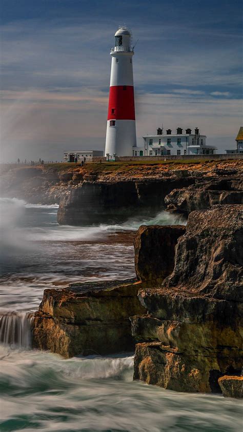 Download Wallpaper 1080x1920 Lighthouse Rocks Sea Spray Water