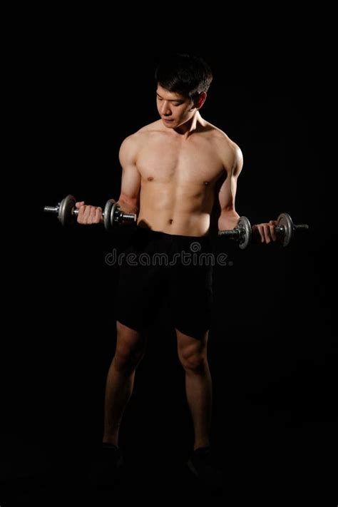 Athletic Muscular Bodybuilder Man With Naked Torso Six Pack Abs Working Out With Dumbbell
