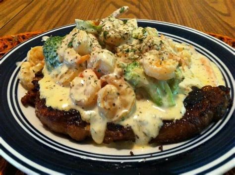 This is my latest attempt. Rib eye steak topped with broccoli and shrimp Alfredo ...