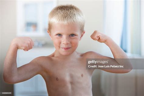 Caucasian Boy Flexing His Muscles High Res Stock Photo Getty Images