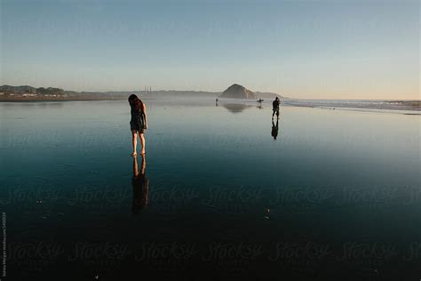 Woman Looking At Her Reflection In The Ocean By Stocksy Contributor