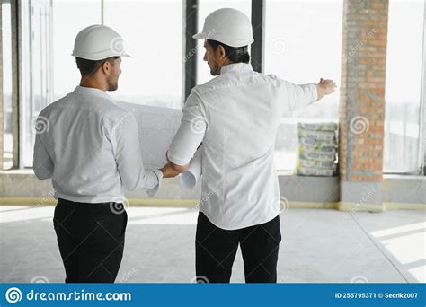 Two Young Man Architect On A Building Construction Site Stock Image