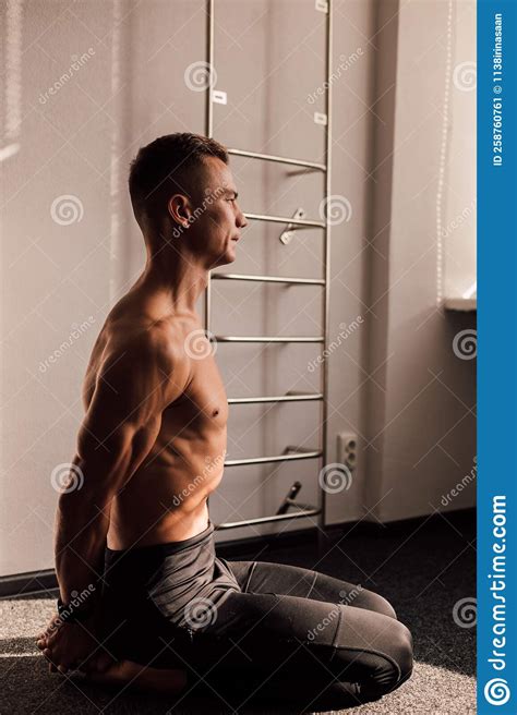 A Man With A Naked Torso Sits On The Floor Athletic Body Stock Image