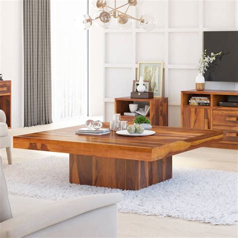 Too small of a coffee table and the setting is disproportionate and there's overreaching to put a glass down. 55" Large Rustic Square Coffee Table With Pedestal
