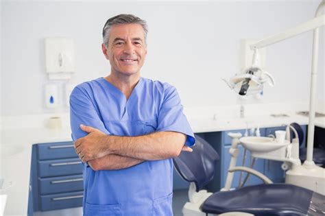 Portrait Of A Friendly Dentist With Arms Crossed In Dental Clinic Cirrus Consulting Group