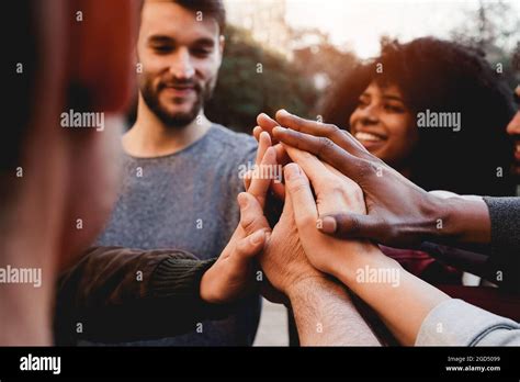 Multiracial Young People Celebrating Together While Stacking Hands