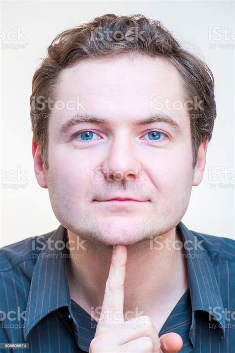 Portrait Of Man Points On His Chin Human Face Parts Stock Photo