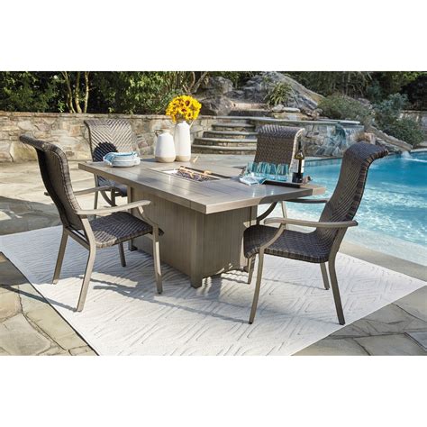 Outdoor fire pit dining table set. Signature Design by Ashley Windon Barn 5-Piece Rectangular ...