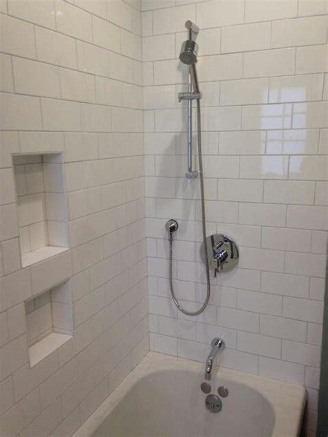 Another good way of incorporating a subway tile to the shower is by mixing the white color with others. Oversize white subway tile light grey grout handheld ...
