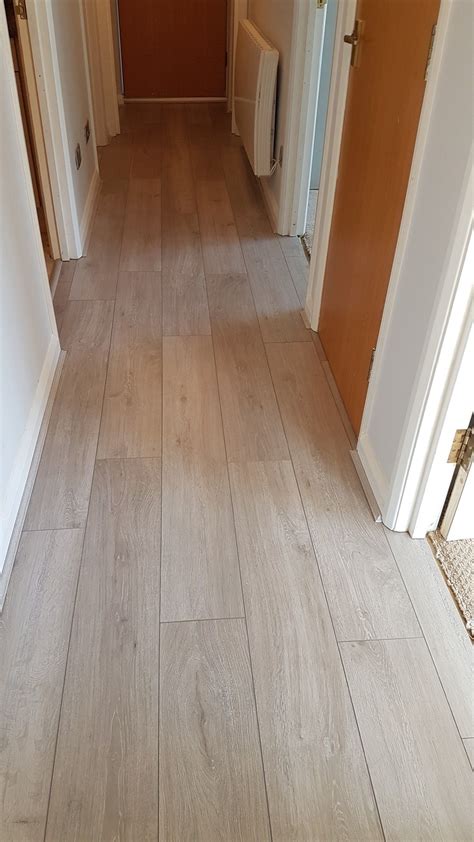 Laminate flooring on walls has become a popular trend in homes and businesses. Laminate flooring, installed by C.H WoodWorx | Flooring, Laminate flooring, Interior