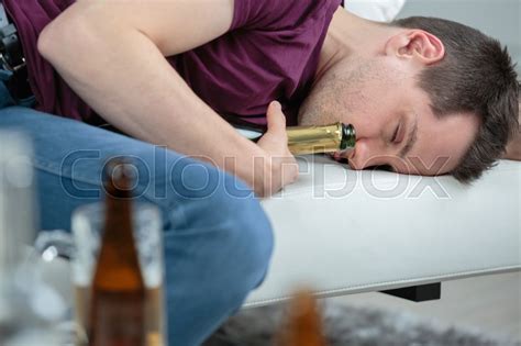Man Fallen Asleep Holding Alcohol Stock Photo Colourbox