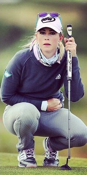 A Woman Kneeling Down Holding A Golf Club