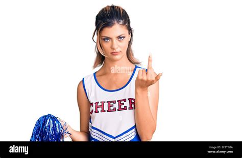 Young Beautiful Woman Wearing Cheerleader Uniform Showing Middle Finger Impolite And Rude Fuck