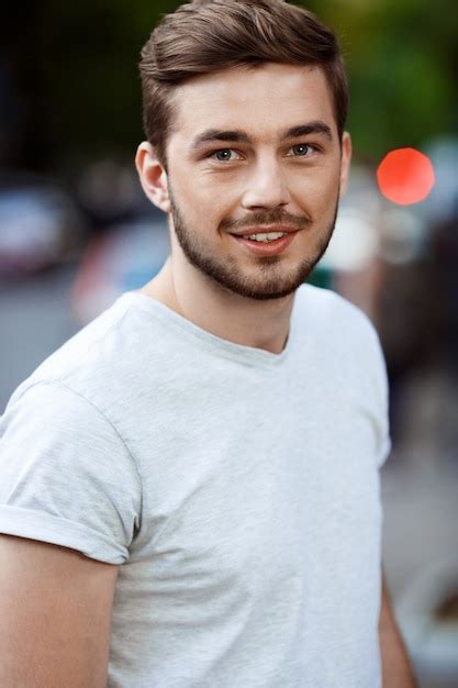 Free Photo Close Up Portrait Of Handsome Smiling Young Man In White T Shirt On Blurry Outdoor