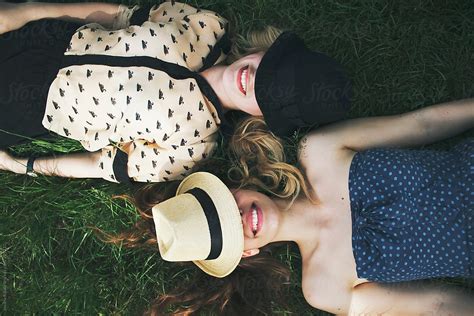Two Female Friends Are Lying On Grass And Laughing By Stocksy Contributor Jovana Rikalo